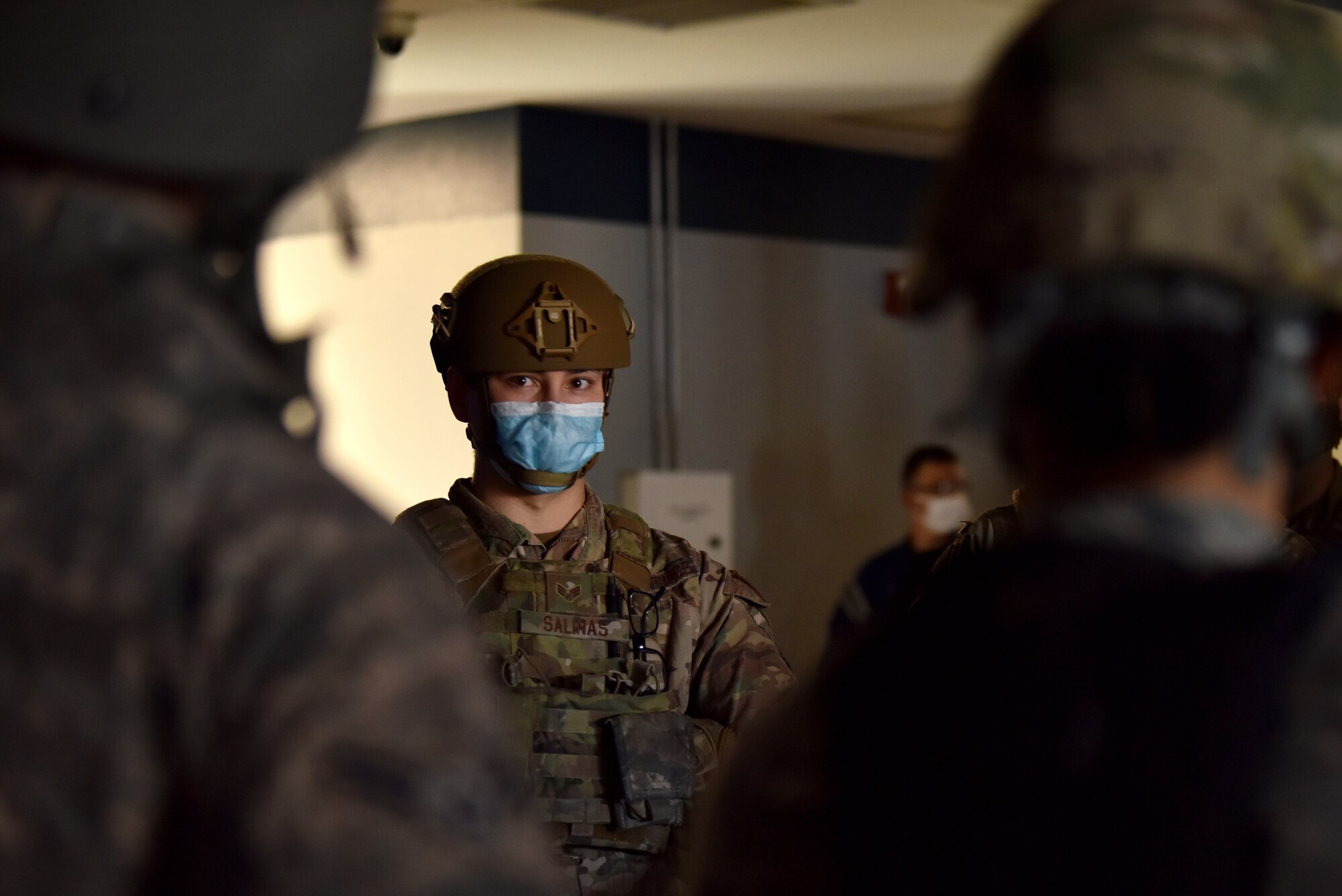 U.S. Air Force Senior Airman Anthony Salinas, 17th Security Forces Squadron patrolman, holds a pre-brief with teammates before entering the final exercise at the Mathis Fitness Center during the Tactical Combat Casualty Care course on Goodfellow Air Force Base, Texas, Feb. 7, 2021. Defenders participated in hands-on exercises to assist in tactical movements and reinforce the ability to work with different unit members. (U.S. Air Force photo by Staff Sgt. Seraiah Wolf)