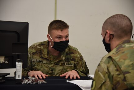 Virginia National Guard Soldiers assigned to the Recruiting and Retention Battalion talk to Soldiers about retention as they out-process following their support to law enforcement in Washington, D.C., Jan. 25, 2021, at Fort Pickett, Virginia. (U.S. Army National Guard photo by Sg. 1st Class Terra C. Gatti)