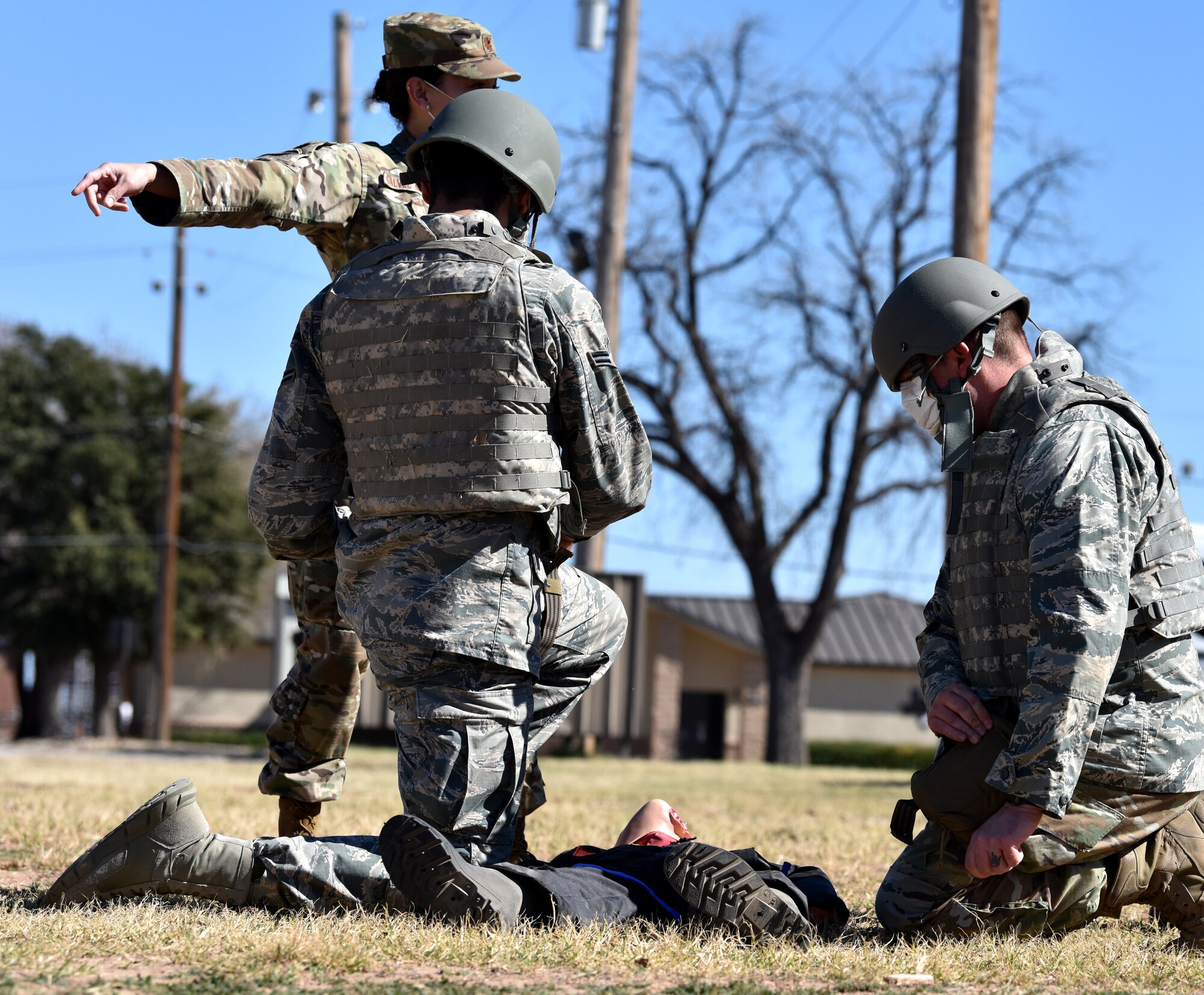 U.S. Air Force Maj. Iveth Galvez Guzman, 17th Medical Group flight commander of military medicine, shouts out simulated injuries located on a mannequin to Tactical Combat Casualty Care course participants behind the Airman and Family Readiness Center on Goodfellow Air Force Base, Texas, Feb. 7, 2021. During the course, participants had to react quickly to simulated injuries explained by instructors or play the role of victim.  (U.S. Air Force photo by Staff Sgt. Seraiah Wolf)