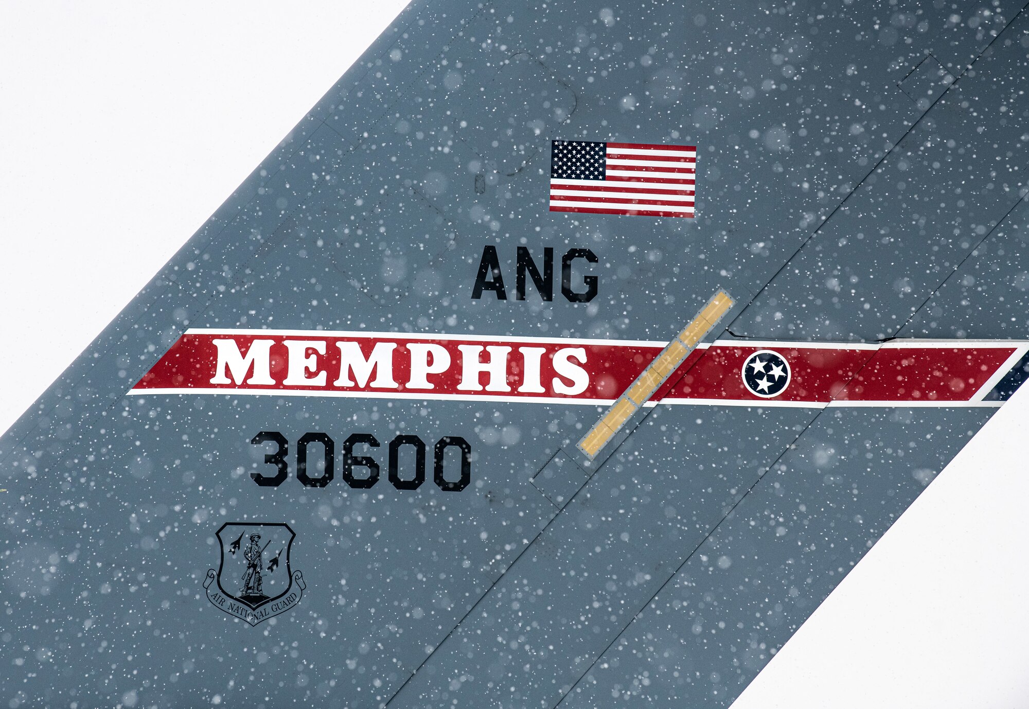 A snow-covered Tennessee Air National Guard C-17 Globemaster III sits on the flight line at Dover Air Force Base, Delaware, Feb. 11, 2021. As snow fell, the base continued normal operations and prepared for additional winter weather. (U.S. Air Force photo by Senior Airman Christopher Quail)