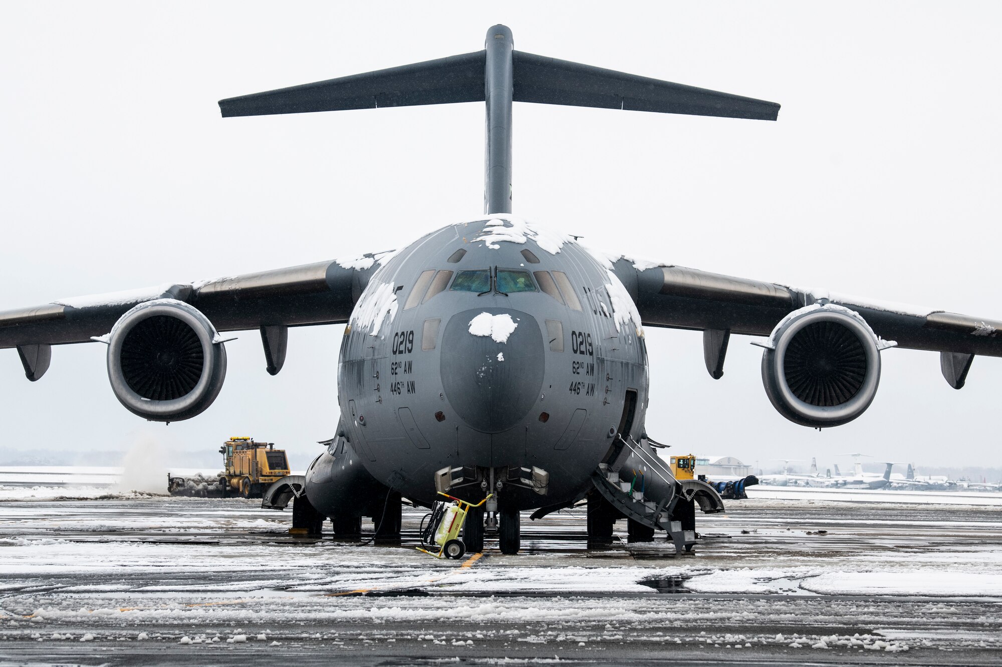 A snow-covered C-17 Globemaster III, assigned to the 62nd Airlift Wing, Joint Base Lewis-McChord, Washington, sits on the flight line at Dover Air Force Base, Delaware, Feb. 11, 2021. As snow fell, the base continued normal operations and prepared for additional snowfall. (U.S. Air Force photo by Senior Airman Christopher Quail)
