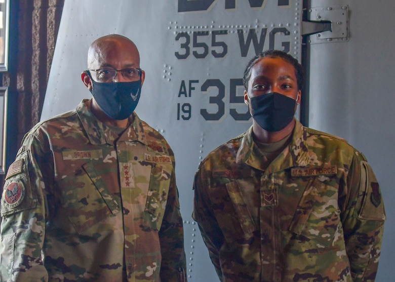 Air Force Chief of Staff, Gen. Charles Q. Brown poses for a photo with Staff Sergeant Giovanni Sims