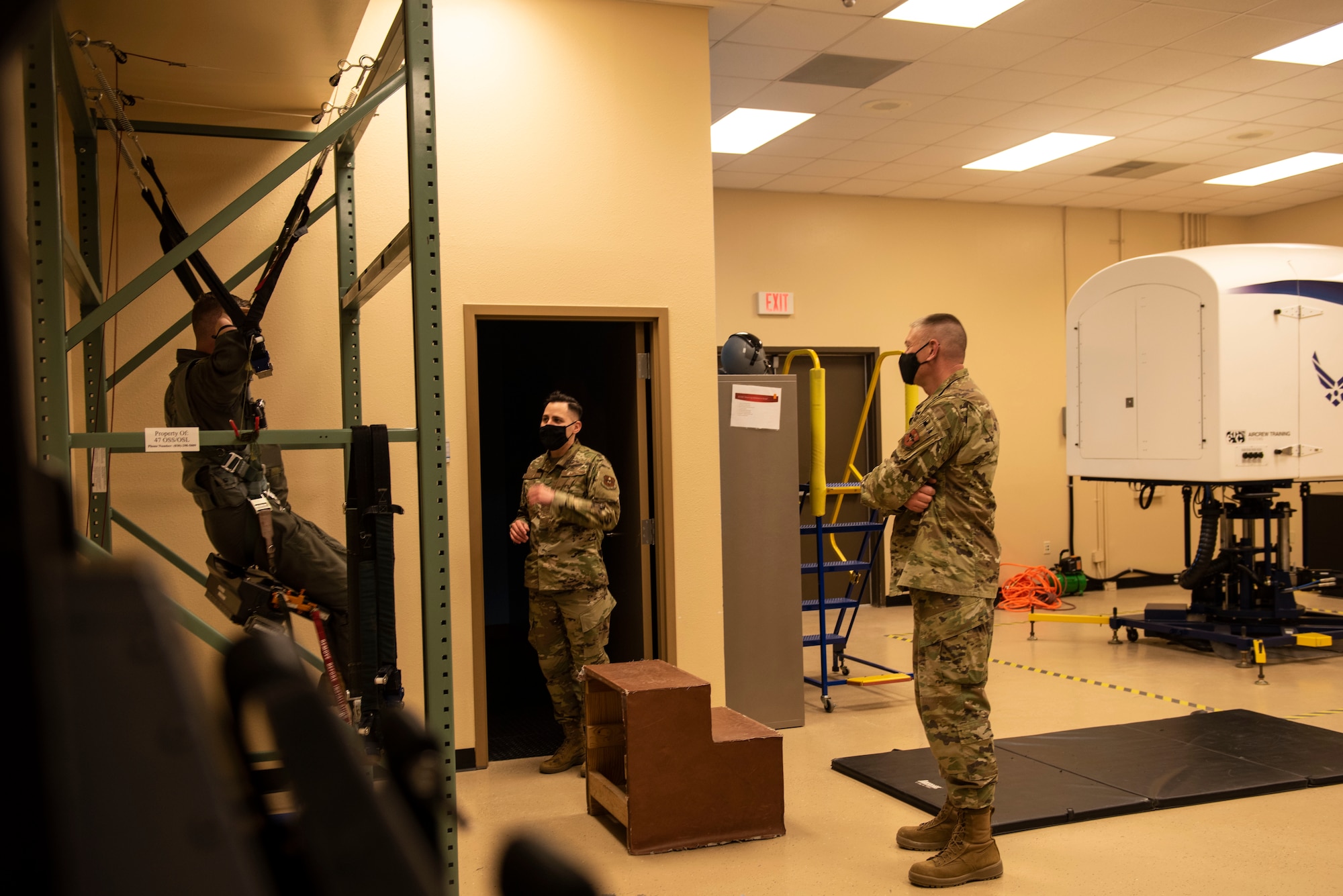 Technical Sgt. David Vazquezvelez, 47th Operations Support Squadron aircrew flight equipment NCOIC, briefs Maj. Gen. William Spangenthal, Air Education and Training Command deputy commander, on proper emergency parachute egress techniques during Spangenthal’s visit to the 47th Aerospace Physiology Squadron at Laughlin Air Force Base, Texas, Feb. 8, 2021. Every student pilot at Laughlin completes this training prior to their first flight. (U.S. Air Force photo by Airman 1st Class David Phaff)