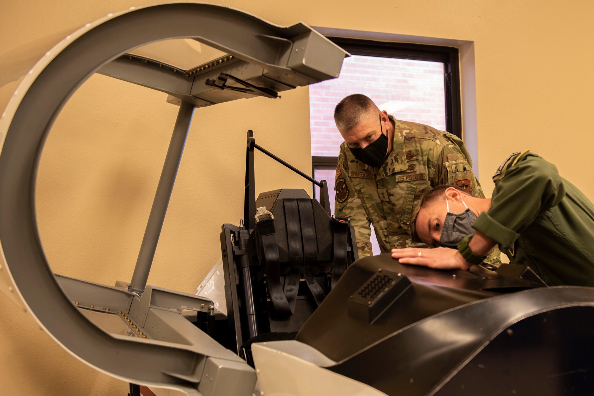 Maj. Gen. William Spangenthal, Air Education and Training Command deputy commander, inspects a model cockpit of a T-6A Texan II at Laughlin Air Force Base, Texas, Feb. 8, 2021. After six weeks of academics, student pilots then become familiar with their first aircraft, the T-6 Texan II, learning basic flying skills and advance aerobatics. (U.S. Air Force photo by Airman 1st Class David Phaff)