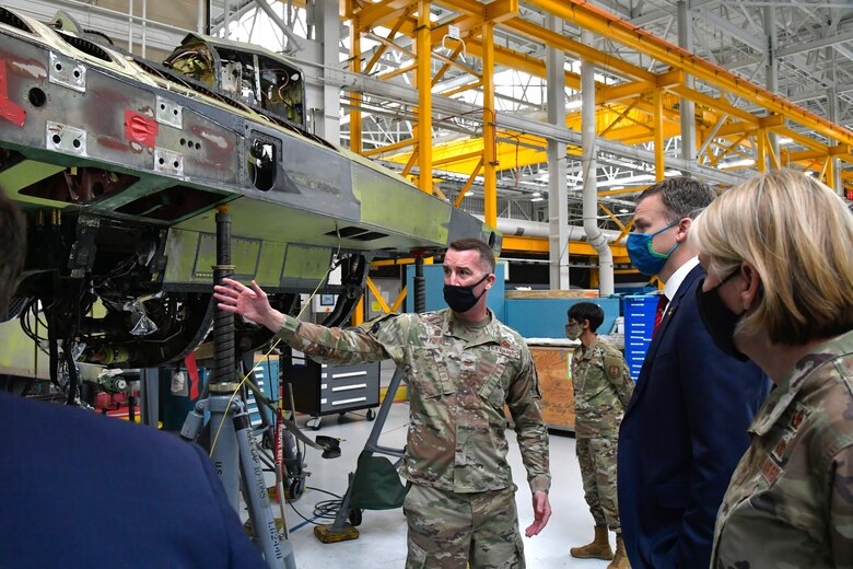 Col. Chris Boring (center), 309th Aircraft Maintenance Group commander, Utah Rep. Blake Moore and Hill leadership about F-16 aircraft maintenance during a visit to Hill Air Force Base, Utah, Feb. 16, 2021.