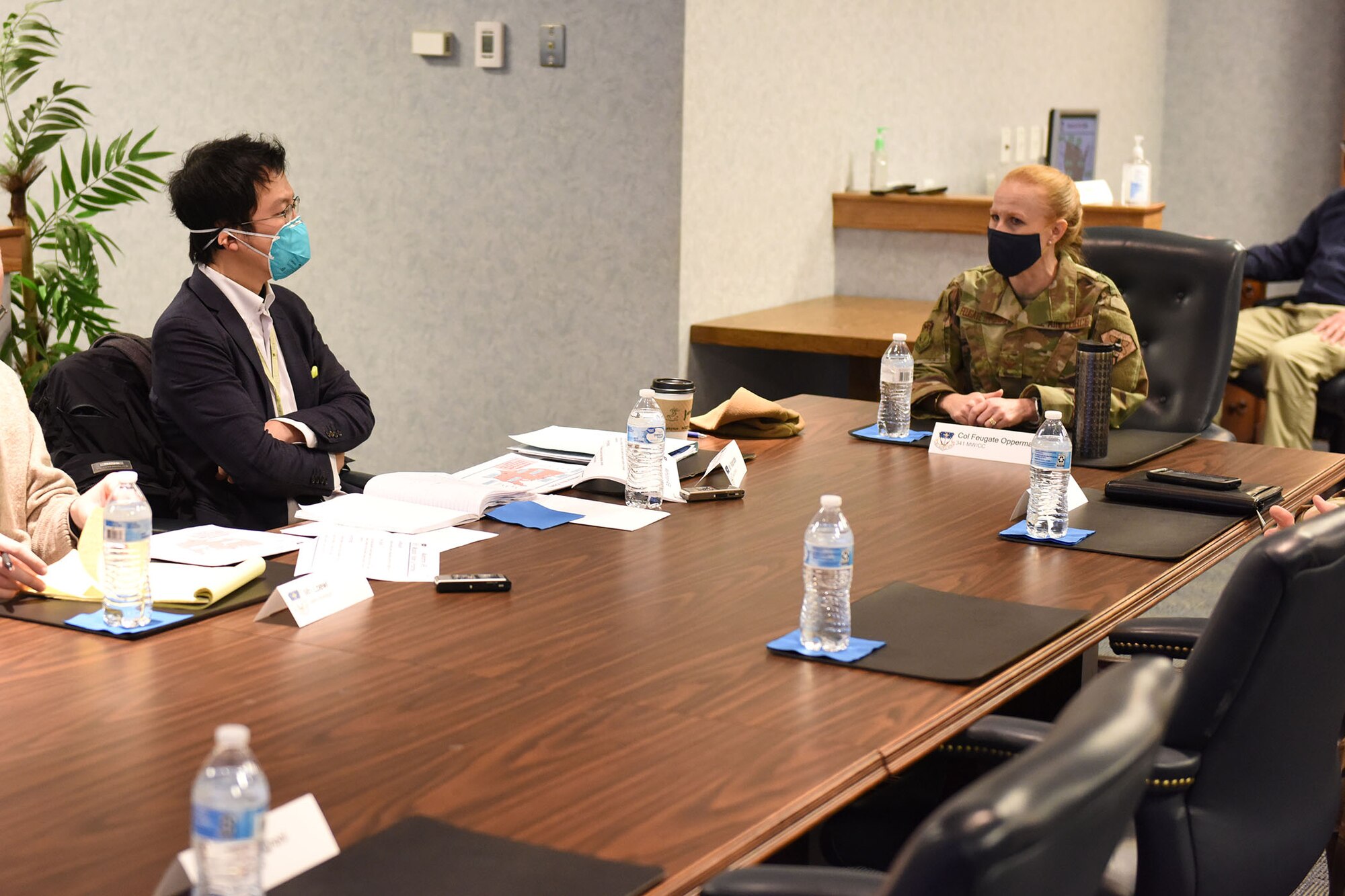 Mr. Takashi Watanabe and Col. Anita Feugate Opperman, 341st Missile Wing commander, sit at a table and discuess the mission brief before the media tour is conducted.