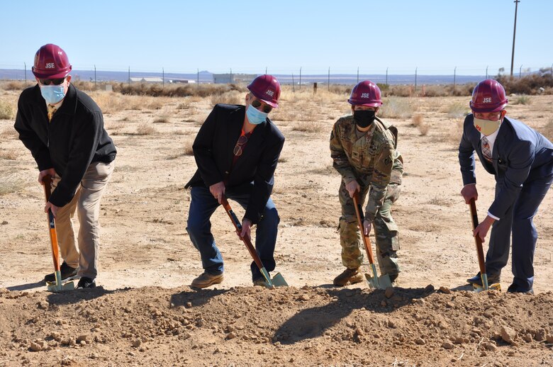 Col. Julie Balten, commander of the U.S. Army Corps of Engineers Los Angeles District, second from right, along with other members of the LA District team, symbolically digs dirt Feb. 18 during a groundbreaking ceremony for the Joint Simulation Environment facility at Edwards Air Force Base, California.