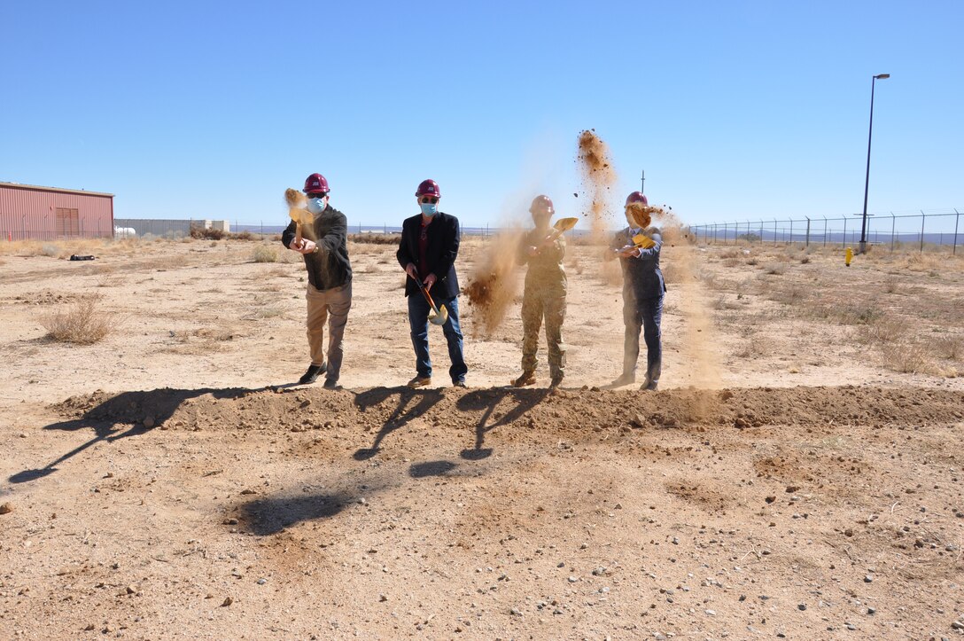 Col. Julie Balten, commander of the U.S. Army Corps of Engineers Los Angeles District, second from right, along with other members of the LA District team, symbolically digs dirt Feb. 18 during a groundbreaking ceremony for the Joint Simulation Environment facility at Edwards Air Force Base, California.