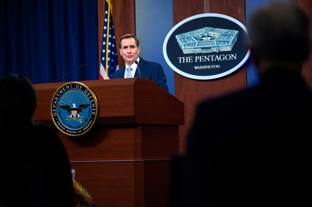 Man speaks while standing at a lectern.