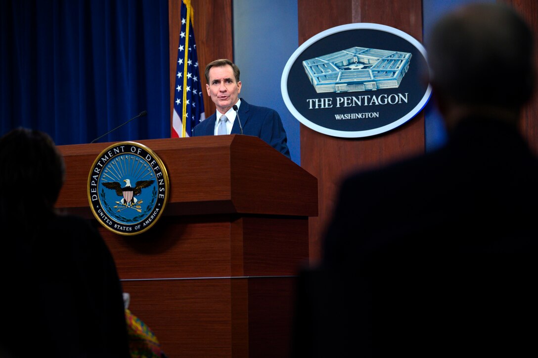 Man speaks while standing at a lectern.