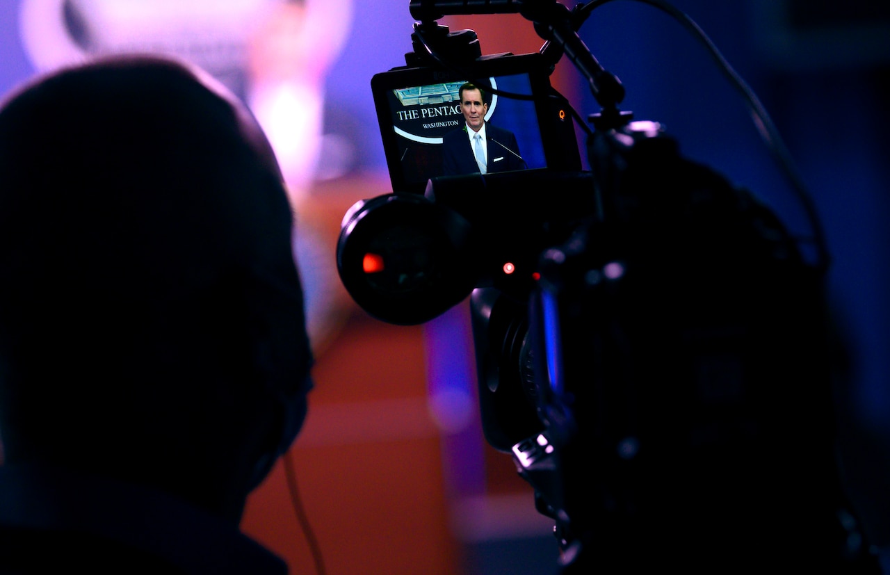 Man speaks while standing at a lectern.