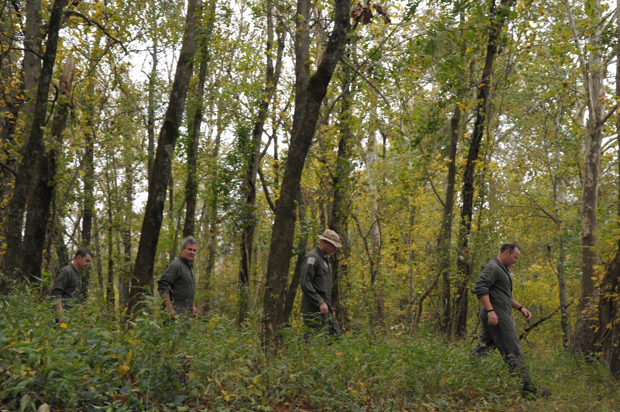 Members of the 908th Operations Group walk through the woods Nov. 8, 2020, at Maxwell Air Force Base, Alabama.