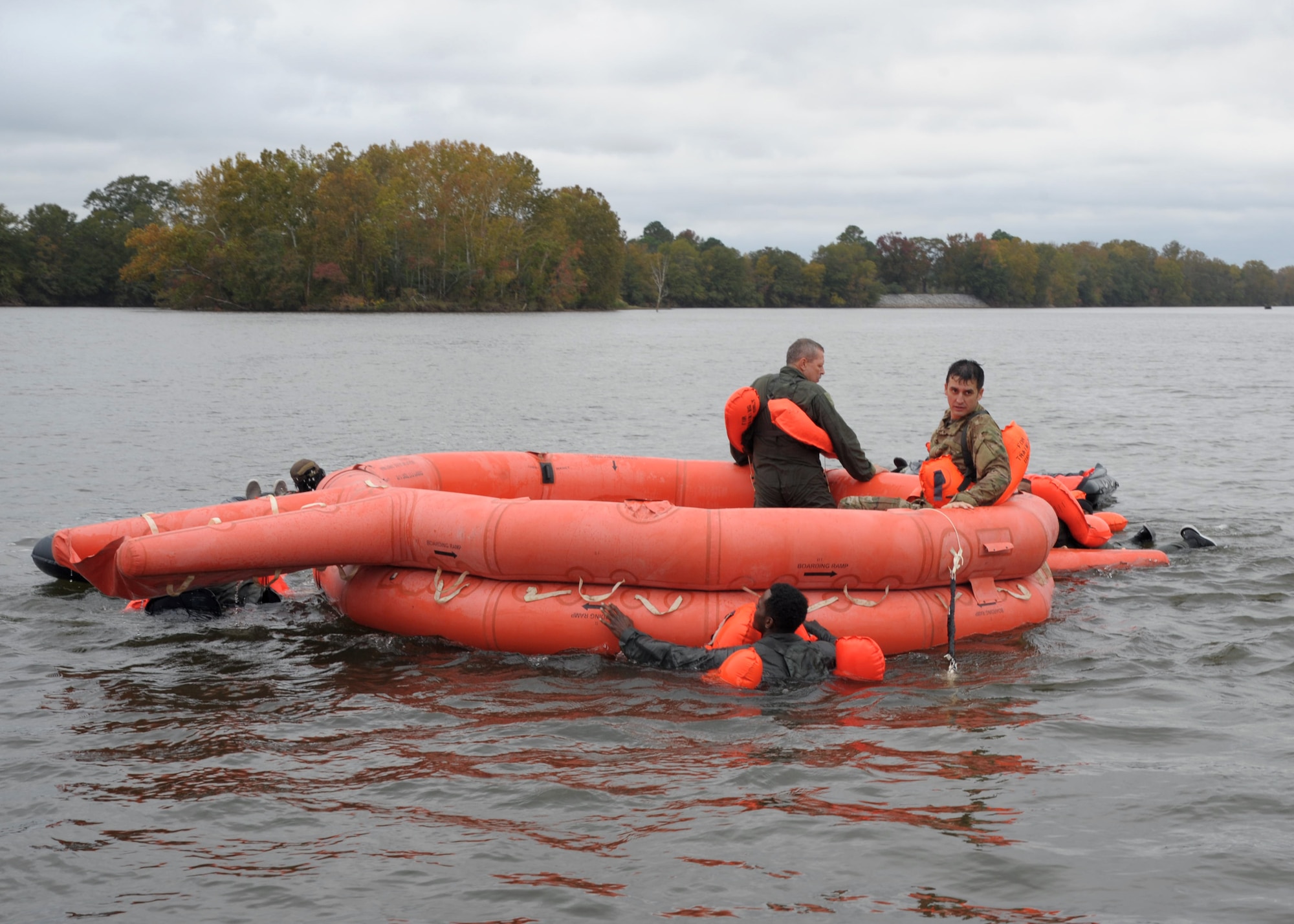 Members of the 908th Operations Group climb aboard a 20-man life raft after being picked up at their designated extraction point Nov. 8, 2020, at Maxwell Air Force Base, Alabama.