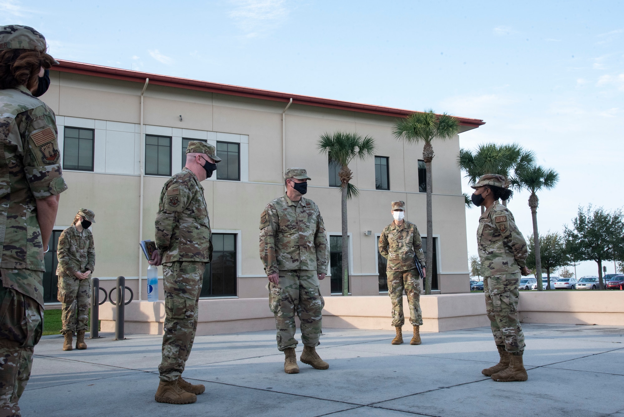 U.S. Air Force Maj. Gen. Thad Bibb Jr., 18th Air Force commander and Chief Master Sgt. Chad Bickley, 18th Air Force command chief listen to a briefing outside of the 6th Medical group, Feb. 19, 2021 at MacDill Air Force Base, Fla.