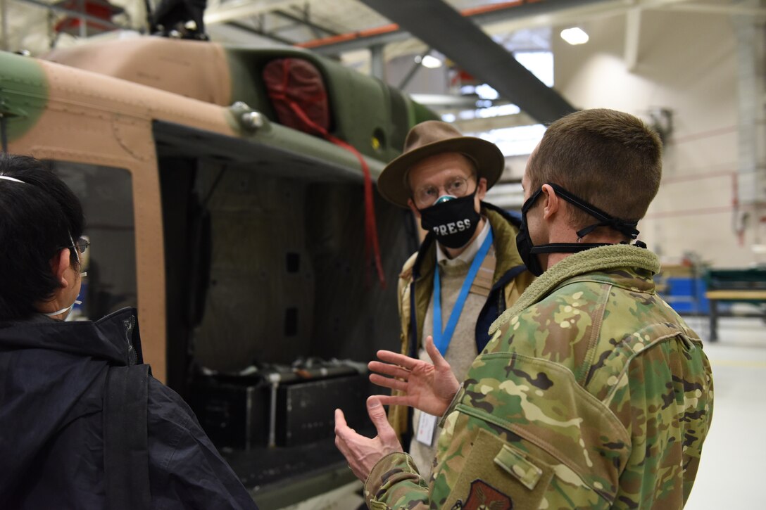 Two media members are given a brief of their helicopter transportation by Lt. Col. Kenneth Green, 40th Helicopter Squadron director of operations.