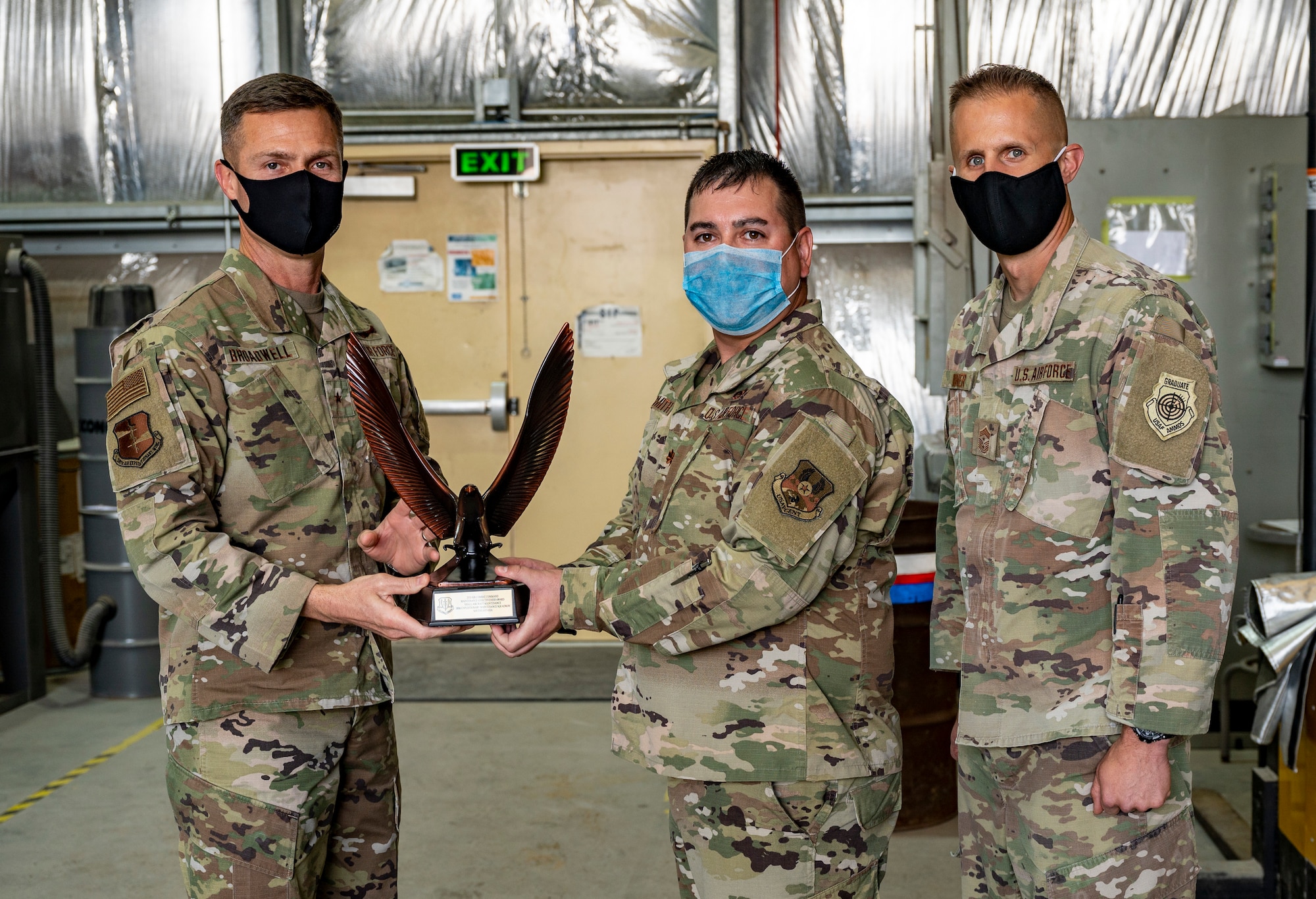 U.S. Air Force Maj. Christopher Smith, 380th Expeditionary Maintenance Squadron commander (center), accepts the 2020 Air Combat Command Maintenance Effectiveness Award for small aircraft maintenance at Al Dhafra Air Base, United Arab Emirates, Feb. 22, 2020.