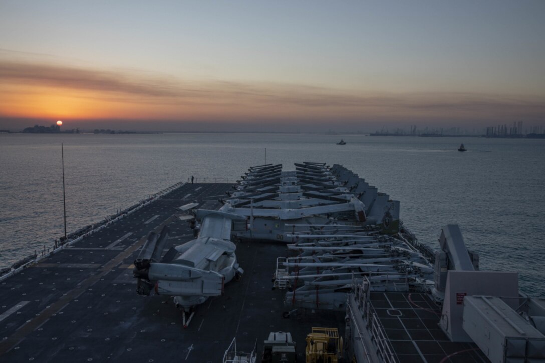 GULF OF BAHRAIN (Feb. 15, 2021) – Amphibious assault ship USS Makin Island (LHD 8) pulls into Manama, Bahrain, during a scheduled port visit in support of logistics and maintenance, Feb. 15. The Makin Island Amphibious Ready Group and the 15th Marine Expeditionary Unit are deployed to the U.S. 5th Fleet area of operations in support of naval operations to ensure maritime stability and security in the Central Region, connecting the Mediterranean and Pacific through the western Indian Ocean and three strategic choke points. (U.S. Navy photo by Mass Communication Specialist 3rd Class Ethan Jaymes Morrow)