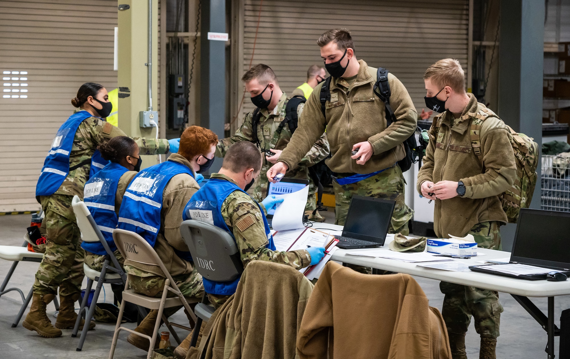 Team Dover members process through a personnel deployment function line during the Liberty Eagle Readiness Exercise on Dover Air Force Base, Delaware, Feb. 17, 2021. The exercise evaluated Team Dover’s ability to rapidly deploy Airmen, Guardians and equipment with limited notice. (U.S. Air Force photo by Senior Airman Christopher Quail)