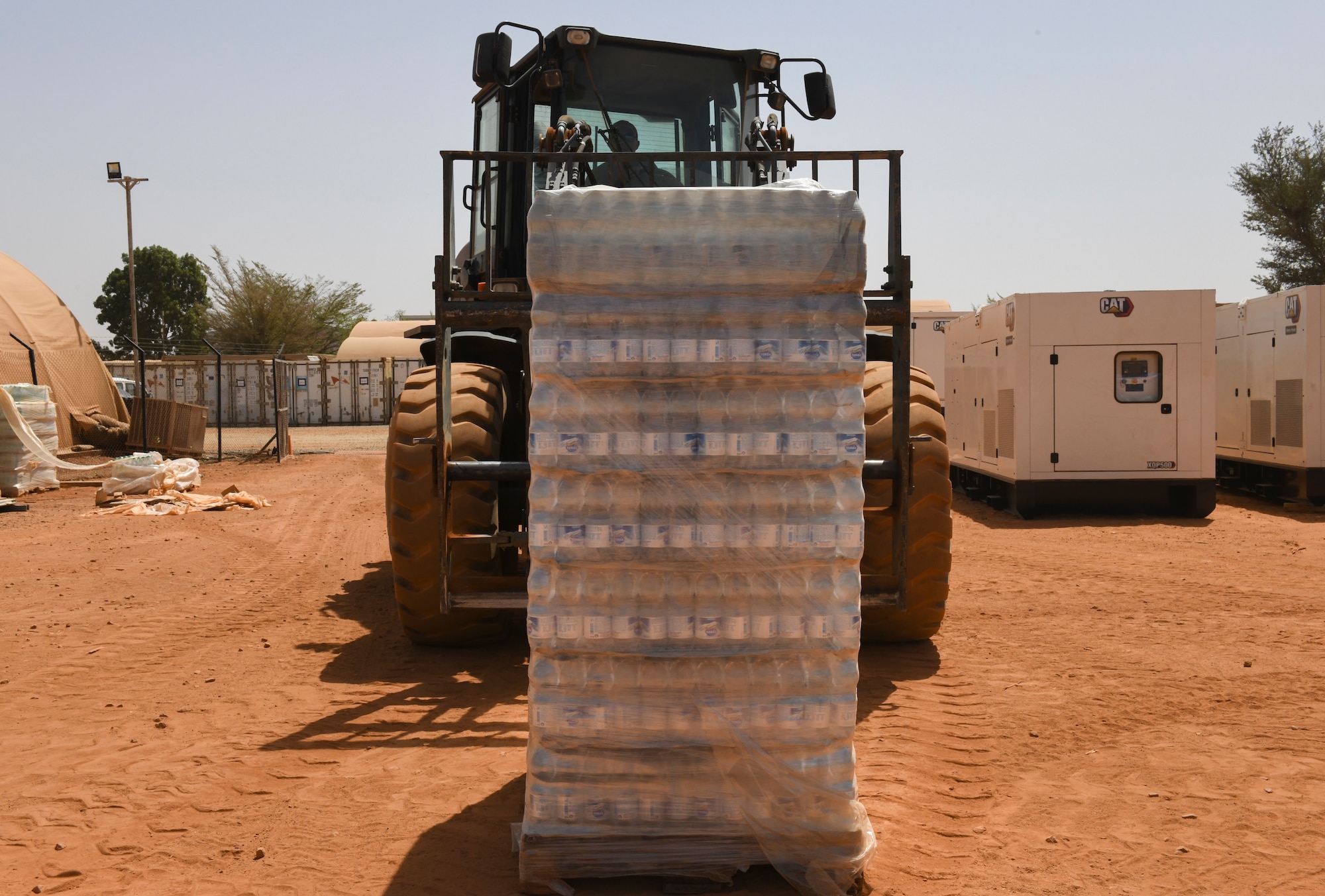 U.S. Air Force Senior Airman Ruben Tala, 768th Expeditionary Air Base Squadron dining facility and storeroom manager, operates a forklift to organize pallets of water that were shipped to Nigerien Air Base 101, Niamey, Niger, Feb. 16, 2021.