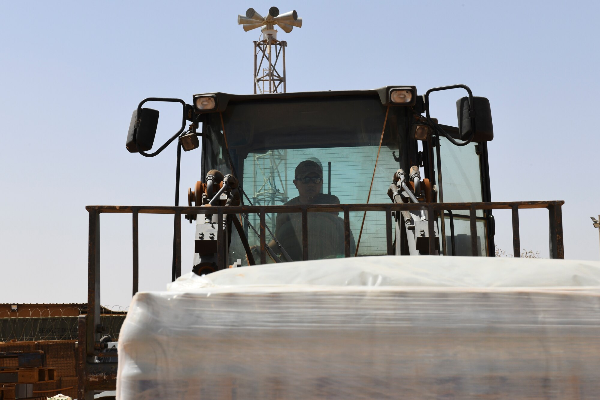 U.S. Air Force Senior Airman Ruben Tala, 768th Expeditionary Air Base Squadron dining facility and storeroom manager, moves pallets of water that were shipped to Nigerien Air Base 101, Niamey, Niger, Feb. 16, 2021.