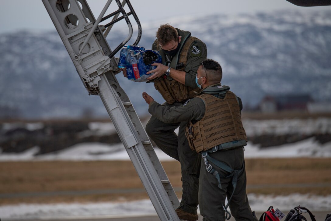 Aircrew assigned to the 9th Expeditionary Bomb Squadron unload a B-1B Lancer at Ørland Air Force Station, Norway, Feb. 22, 2021. The 9th EBS is operating out of Norway in support of a Bomber Task Force deployment. Conducting BTF missions allows theater familiarization for aircrew members and opportunities for United States integration with NATO allies and regional partners. (U.S. Air Force photo by Airman 1st Class Colin Hollowell)