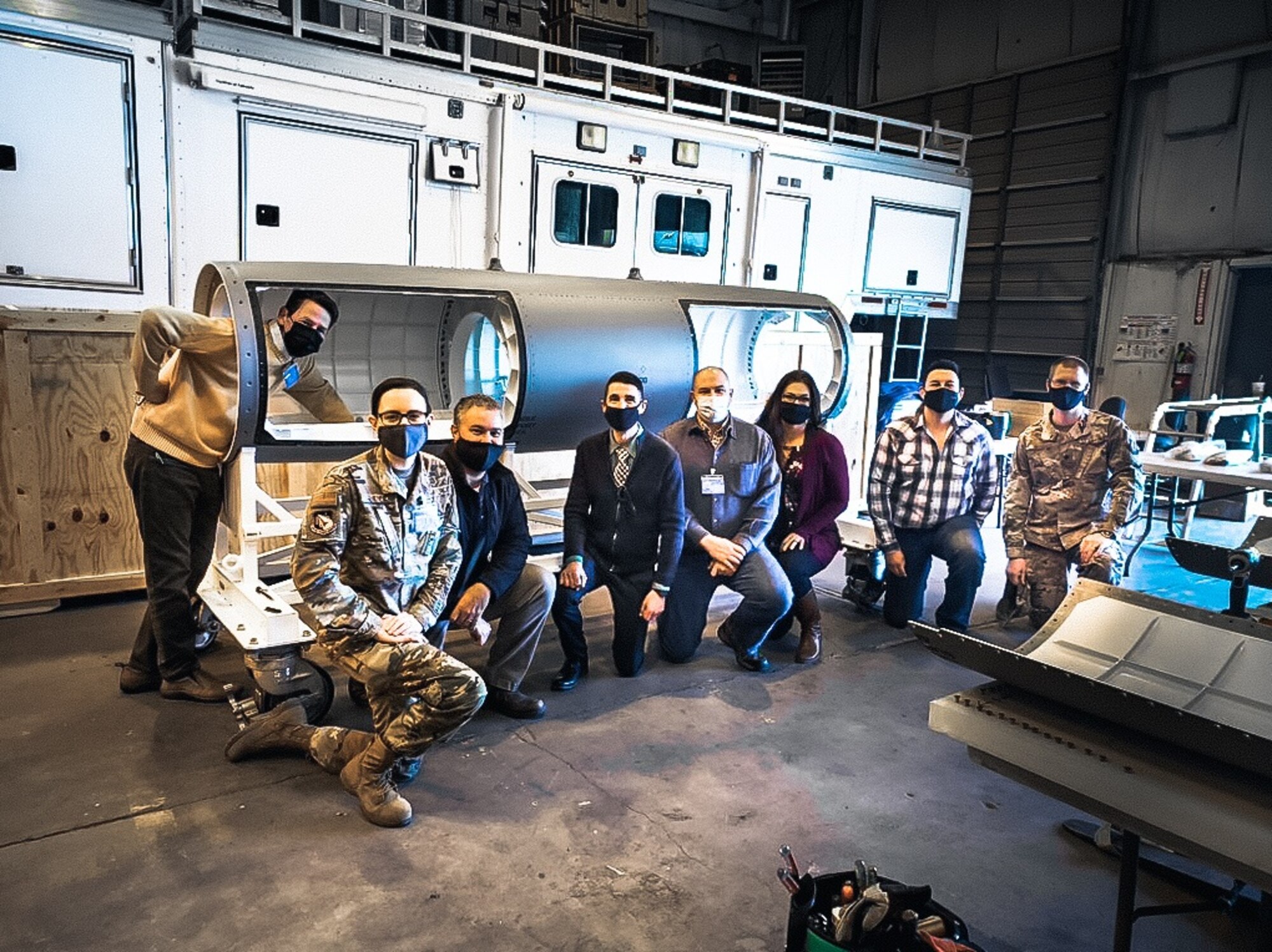 Members of the SHiELD program and their Boeing contractor team inspect the newly arrived SHiELD pod, which will be equipped with additional assembly pieces later this spring.  (Photo: courtesy Boeing)