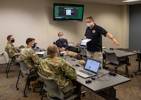 Ken Trate, a current operations directorate member assigned to Joint Task Force Civil Support, briefs Task Force Medical, Logistics, and Operations officers prior to commencing a command post exercise, Feb. 22, 2021.