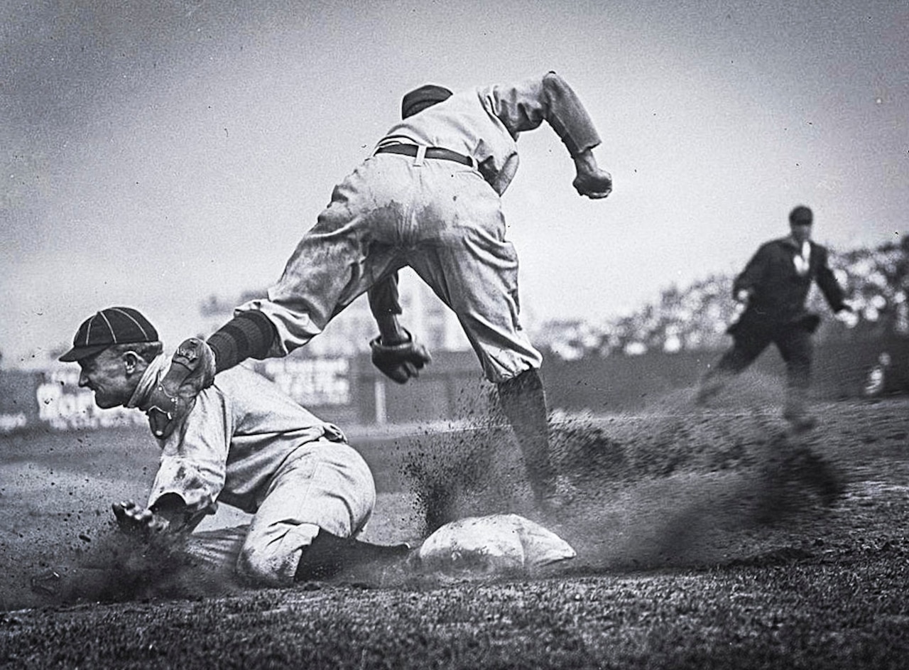 A baseball player slides to base.