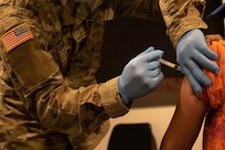 U.S. Army Spc. Cody Taylor, a medic with 531st Hospital Center, Fort Campbell, Ky., administers a COVID-19 vaccine into a patient at First Baptist Church of Lincoln Gardens in Somerset, N.J., Feb. 17, 2021.