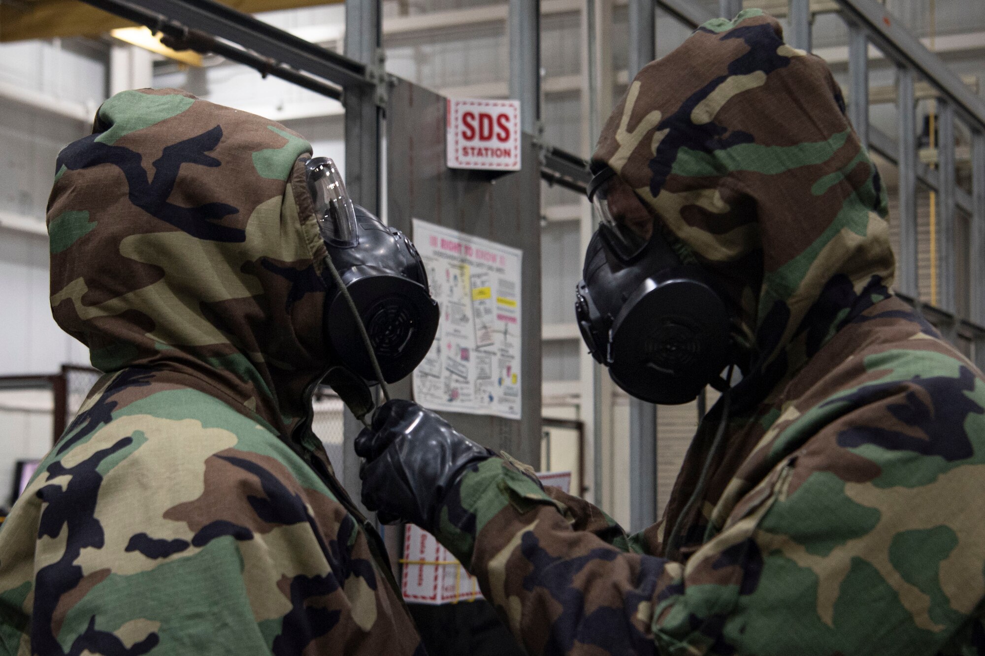 Photo of an Airmen performing a buddy check.
