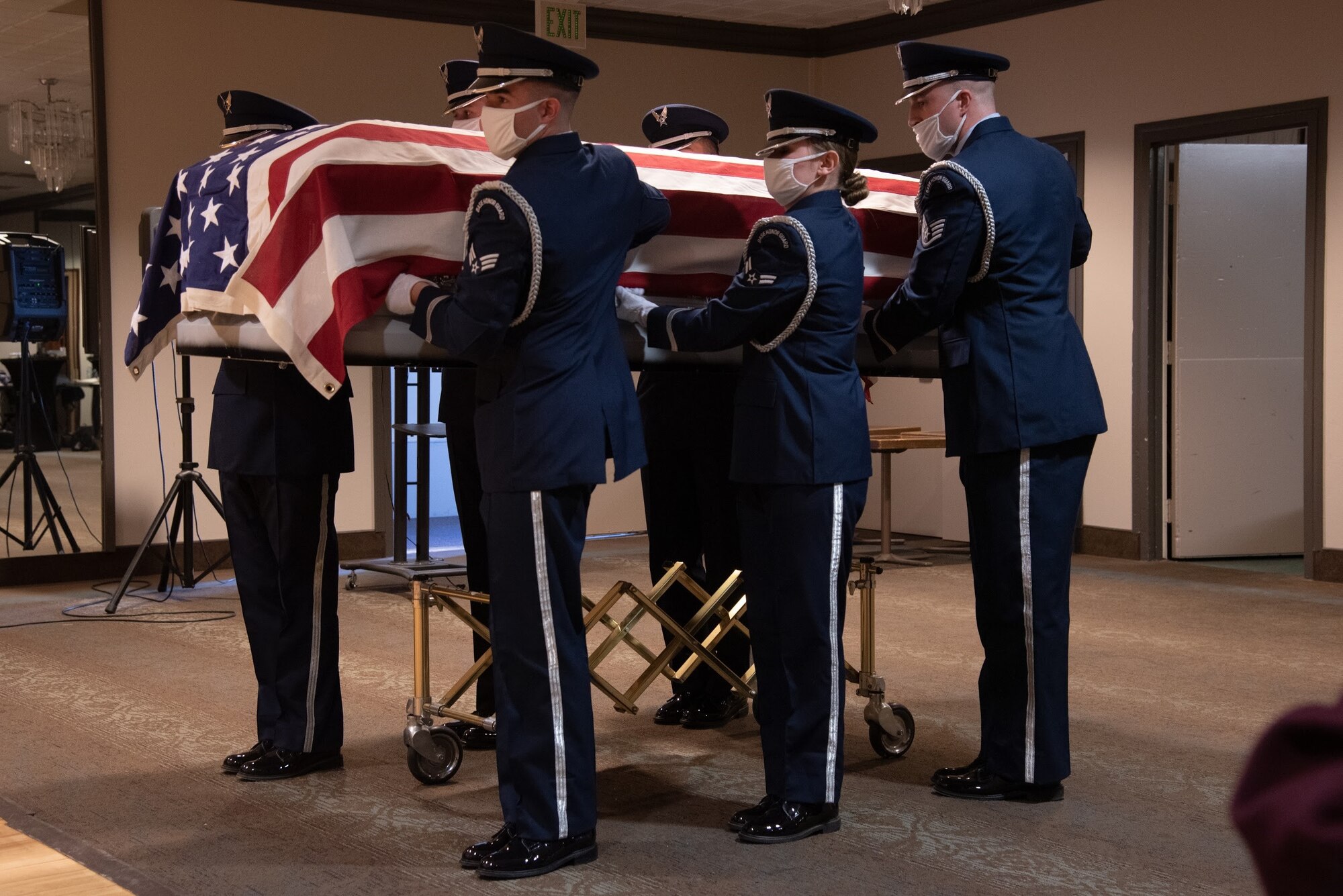 People hold casket