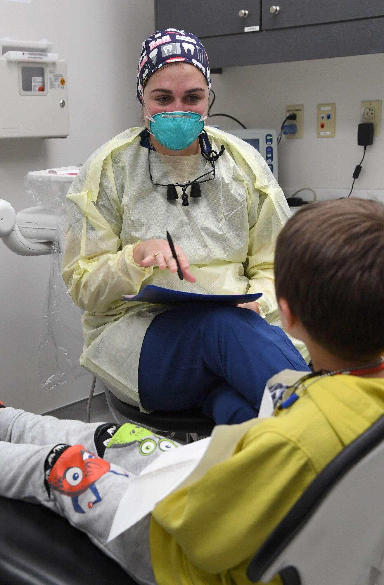U.S. Air Force Capt. (Dr.) Emily Doe, 81st Dental Squadron general dentist, conducts a dental exam on Tobias Whitfield, son of Airman 1st Class James Whitfield, 85th Engineering Installation Squadron radio frequency transmissions technician, during the 10th Annual Give Kids a Smile Day at the dental clinic inside the Keesler Medical Center at Keesler Air Force Base, Mississippi, Feb. 17, 2021. The event was held in recognition of National Children's Dental Health Month and included free dental exams and cleanings for children ages 1-12. (U.S. Air Force photo by Kemberly Groue)