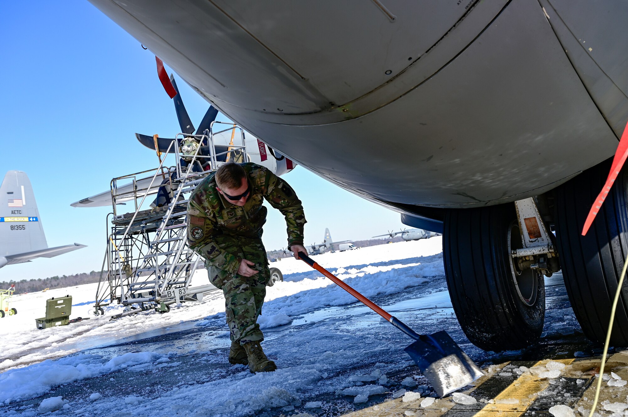 A person clears ice