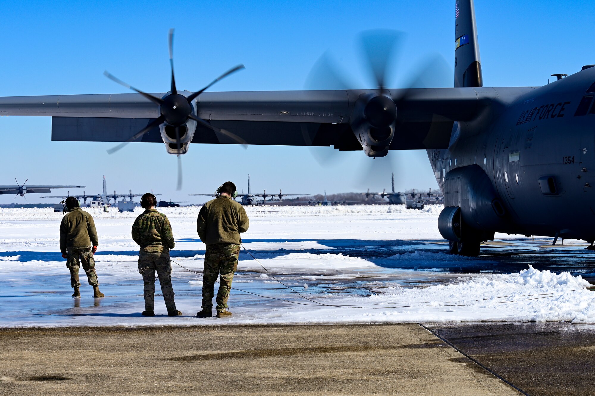 People perform pre-flight inspections