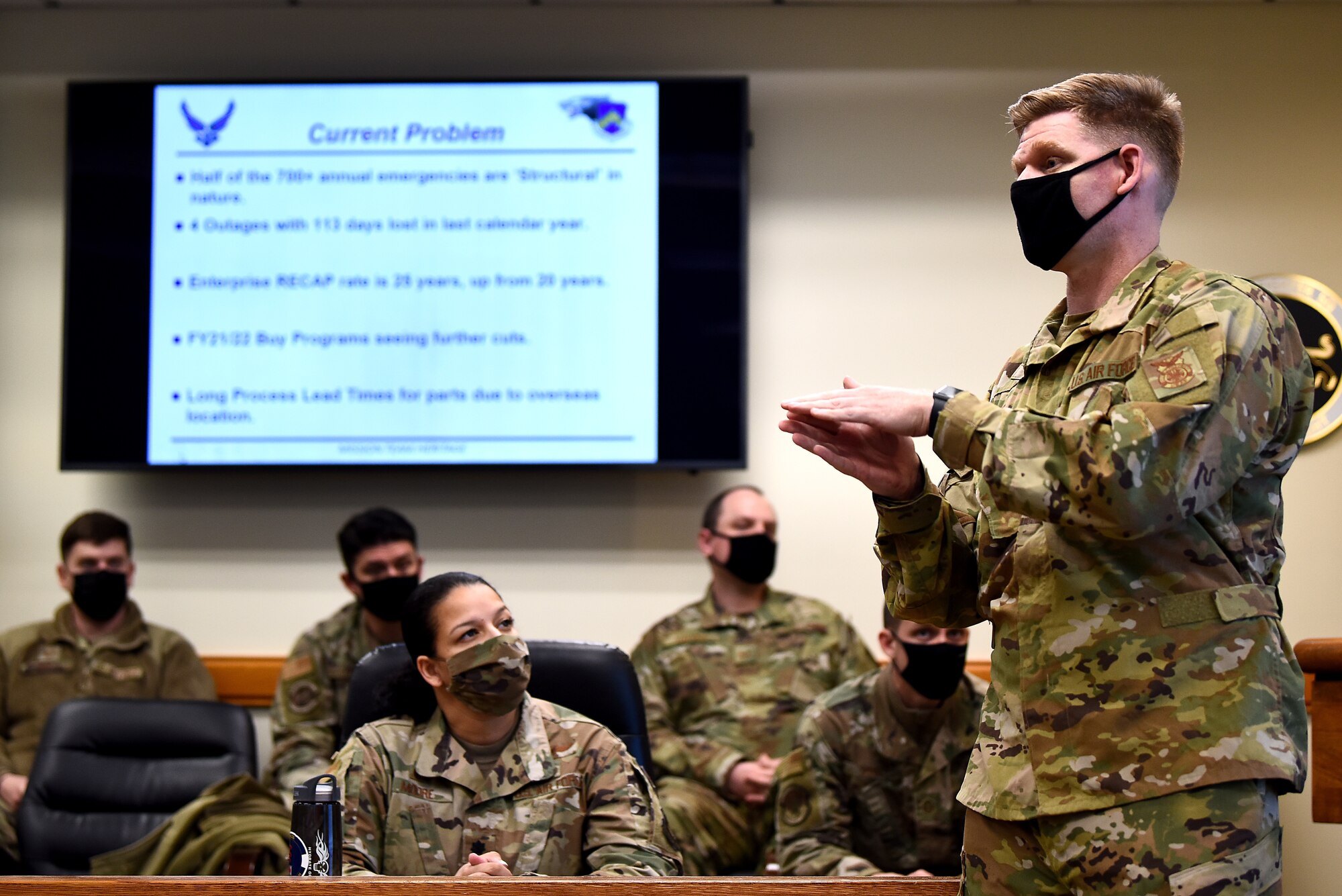 Audience members listen as Senior Master Sgt. AJ Kehl, 8th Civil Engineer Squadron Fire Department fire chief, pitches a fire pump panel simulator during a Wolf Tank in the 8th Fighter Wing conference room at Kunsan Air Base, Republic of Korea, Feb. 17, 2021. Wing leadership selected three of the five ideas to receive full or partial funding, including the fire pump panel simulator, 3D printers and exoskeleton bionic vests. (U.S. Air Force photo by Senior Airman Suzie Plotnikov)