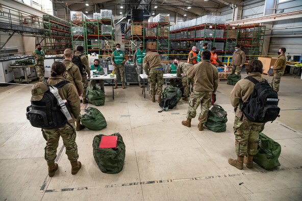 Members of Team Dover wait in a personnel deployment processing line during the Liberty Eagle Readiness Exercise on Dover Air Force Base, Delaware, Feb. 17, 2021. The exercise evaluated Team Dover’s ability to rapidly deploy Airmen, Guardians and equipment with limited notice. (U.S. Air Force photo by Senior Airman Christopher Quail)