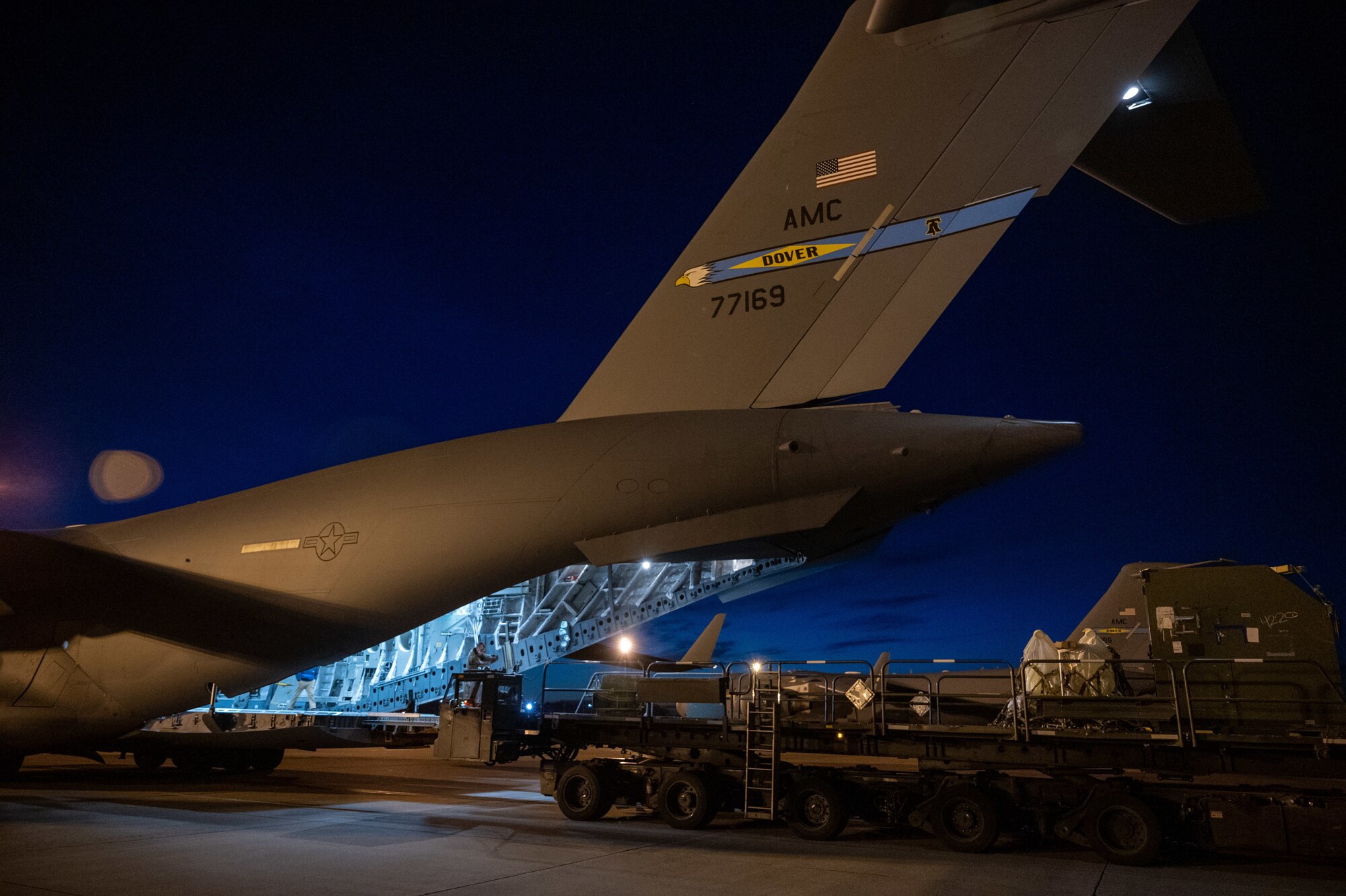 436th Aerial Port Squadron Airmen position a K-loader at the ramp of a C-17 Globemaster III to load cargo during a simulated deployment exercise at Dover Air Force Base, Delaware, Feb. 17, 2021. The Liberty Eagle Readiness Exercise evaluated Team Dover’s ability to rapidly deploy Airmen, Guardians and equipment with limited notice. (U.S. Air Force photo by Airman 1st Class Faith Schaefer)