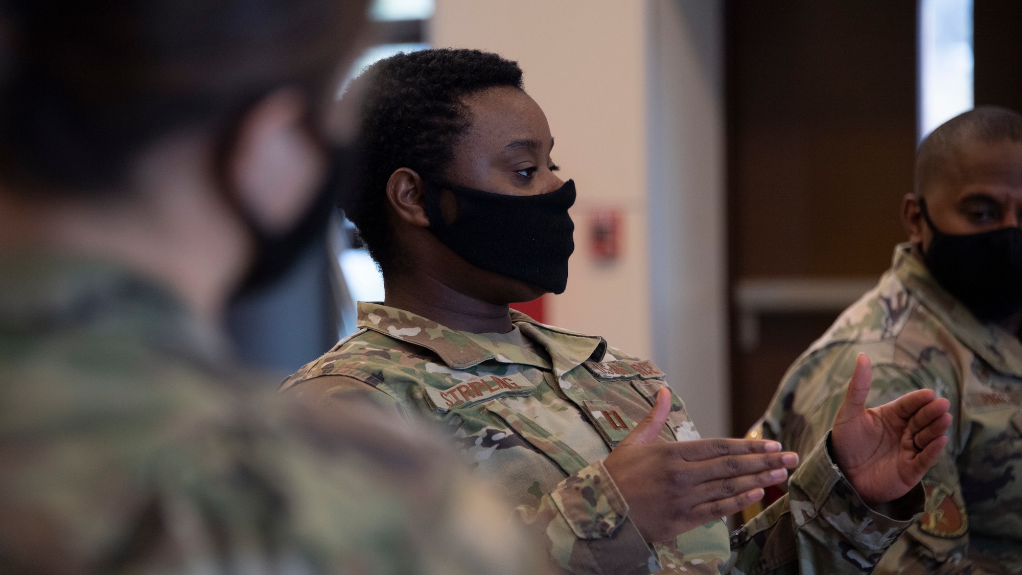 A close-up of a black female officer gesturing while she talks