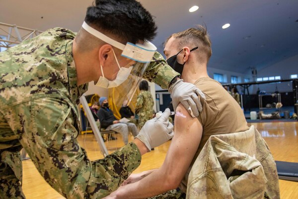 YOKOSUKA, Japan (Jan. 7, 2021) Machinist’s Mate (Nuclear) 1st Class Jason Zeger, assigned to the U.S. Navy’s only forward-deployed aircraft carrier, USS Ronald Reagan (CVN 76), receives the COVID-19 vaccine on Commander, Fleet Activities Yokosuka (CFAY). Medical personnel and strategic forces were the first to receive the COVID-19 vaccine. Ronald Reagan returned to Yokosuka in November 2020 following a six-month deployment in the U.S. 7th Fleet area of responsibility.