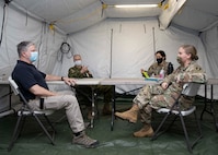 Joint Task Force Civil Support (JTF-CS) Deputy to the Commanding General Michael Collins, and XVIII Airborne Corps Assistant Commanding General, Canadian Brig. Gen., Robert Ritchie meet with the 44th Medical Brigade executive officer, Lt. Col. Crista Wagner, and the command's chief of operations, Maj. Rebecca Sinclair during a command post training exercise on Fort Bragg, N.C., Feb. 23, 2021.