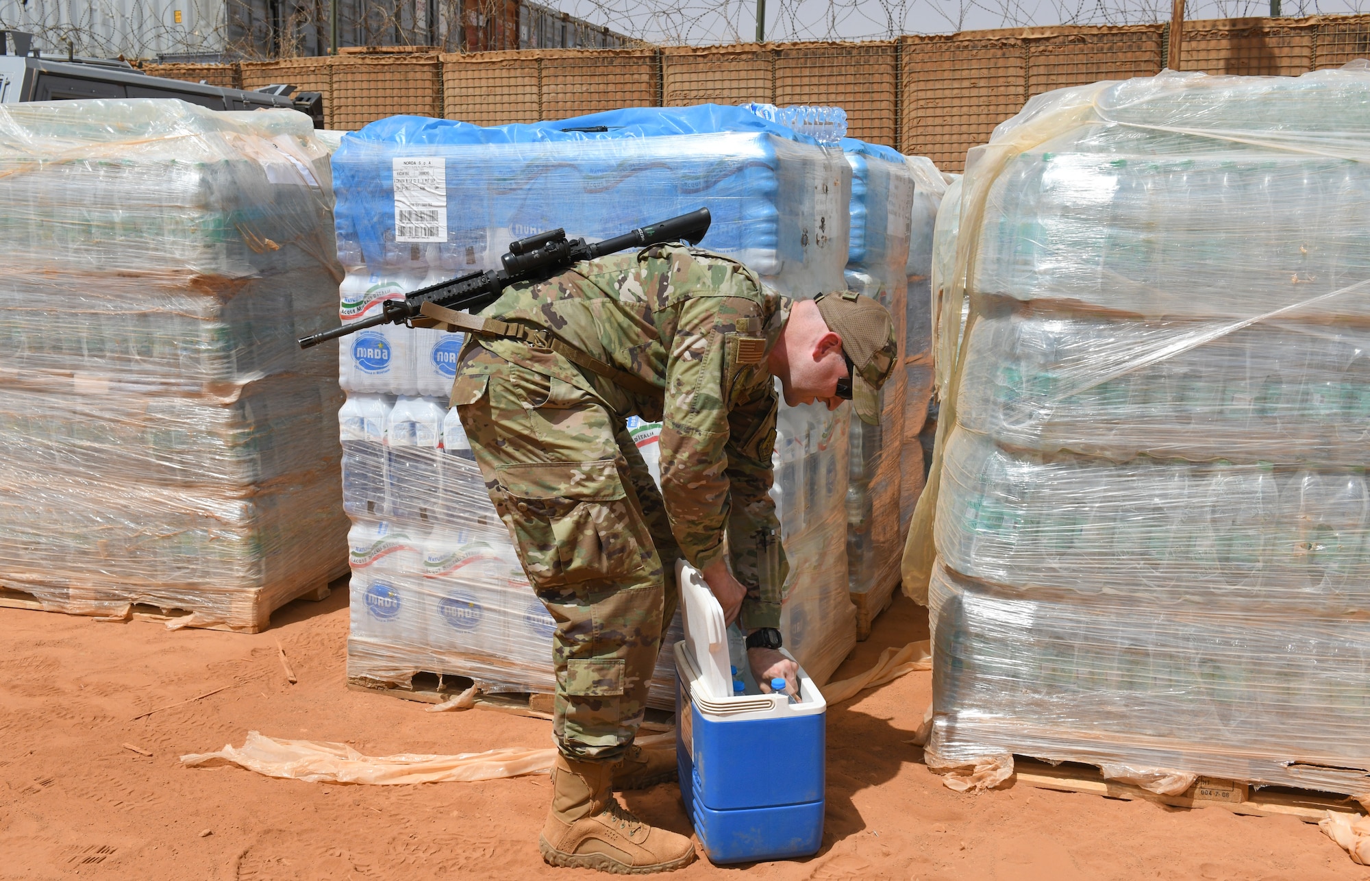 U.S. Air Force Tech. Sgt. Kristopher Beckwith, 768th Expeditionary Air Base Squadron bioenvironmental engineer, selects random water bottles to test water quality that comes from off base sources at Nigerien Air Base 101, Niamey, Niger, Feb. 16, 2021.