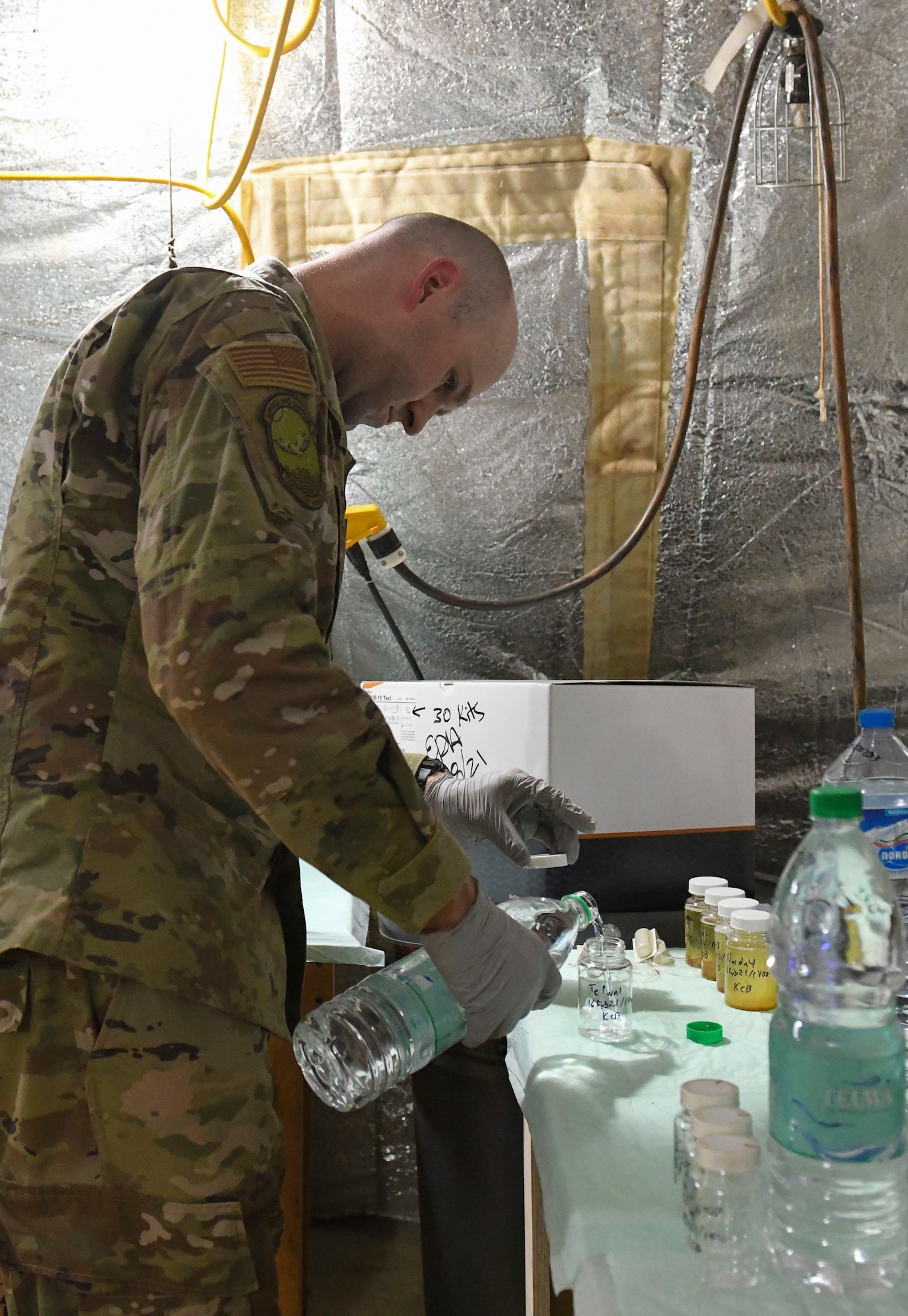 U.S. Air Force Tech. Sgt. Kristopher Beckwith, 768th Expeditionary Air Base Squadron bioenvironmental engineer, pours water into a glass jar to test the drinking quality at Nigerien Air Base 101, Niamey, Niger, Feb. 16, 2021.
