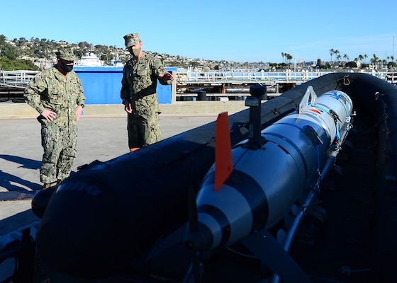 Operations Specialist 1st Class Sean McNamara, an unmanned systems (UMS) operator assigned to Explosive Ordnance Disposal Mobile Unit (EODMU) 1, discusses the capabilities of the Mark 18 family of unmanned underwater vehicles (UUV) with Chief of Naval Operations Adm. Mike Gilday at Naval Base Point Loma.