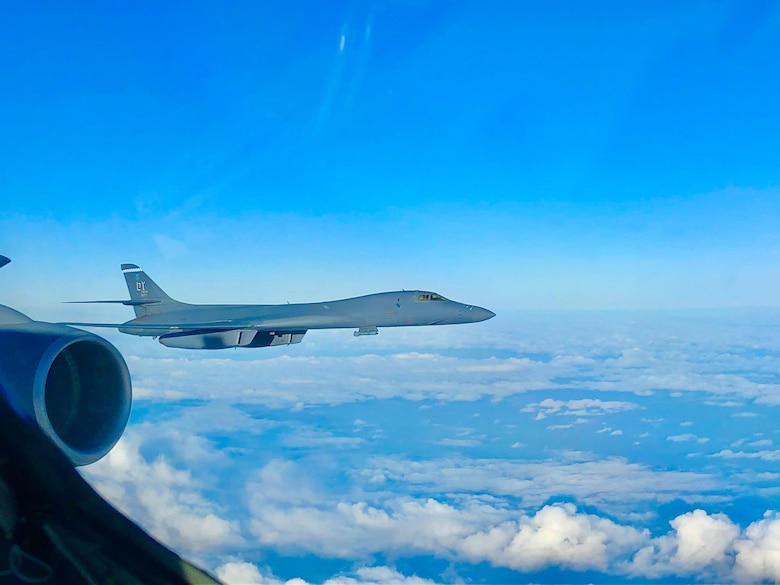 A U.S. Air Force B-1B Lancer aircraft assigned the 7th Bomb Wing, Dyess Air Force Base, Texas, flies off the wing of a KC-135 Stratotanker aircraft assigned to the 100th Air Refueling Wing, Royal Air Force Mildenhall, England, after receiving fuel during a Bomber Task Force Europe mission, Feb. 22, 2021. The U.S. routinely and visibly demonstrates commitment to allies and partners through the global employment of its military forces. (Courtesy photo by Staff Sgt. Blake Soule)