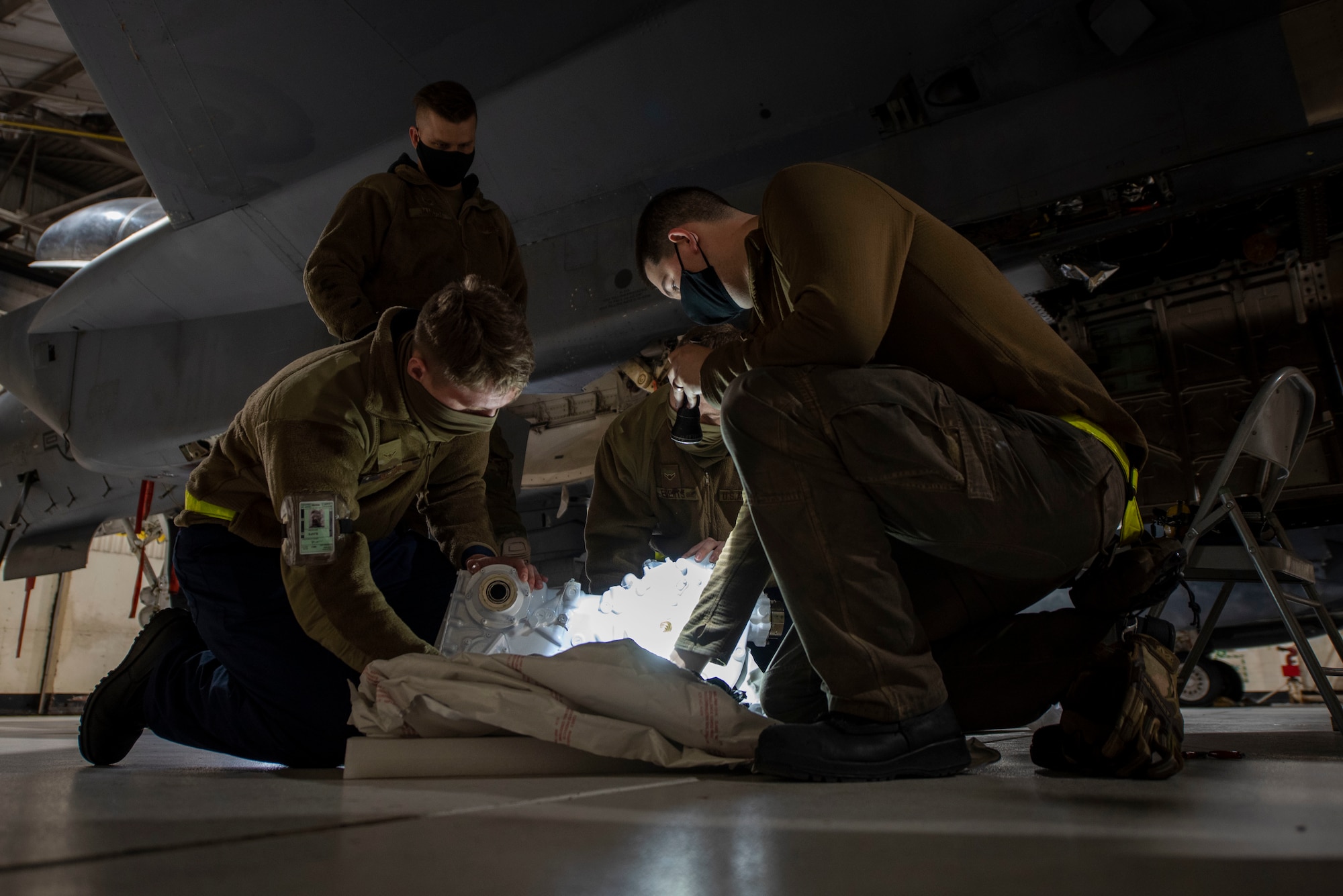 Avionics technicians from the 336th Fighter Squadron, inspect an airframe mounted accessory drive at Seymour Johnson Air Force Base, North Carolina, Feb. 18, 2021.