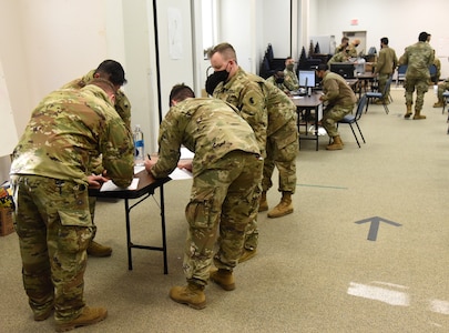 Virginia National Guard Soldiers assigned to the Virginia Beach-based 329th Regional Support Group guide VNG Soldiers returning from duty supporting law enforcement in Washington, D.C. through the reverse reception, staging, onward movement and integration process Feb. 8, 2021, at Fort Pickett, Virginia.