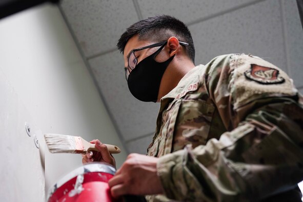 Senior Airman Deven Tsuchiyama, 647th Civil Engineer Squadron structures apprentice, paints a classroom in the Chief Master Sgt. of the Air Force James C. Binnicker Professional Military Education Center at Joint Base Pearl Harbor-Hickam, Hawaii, Jan. 13, 2021. The PME Center underwent a large renovation to update the classrooms and equip them for future classes. (Air Force photo by Airman 1st Class Makensie Cooper)