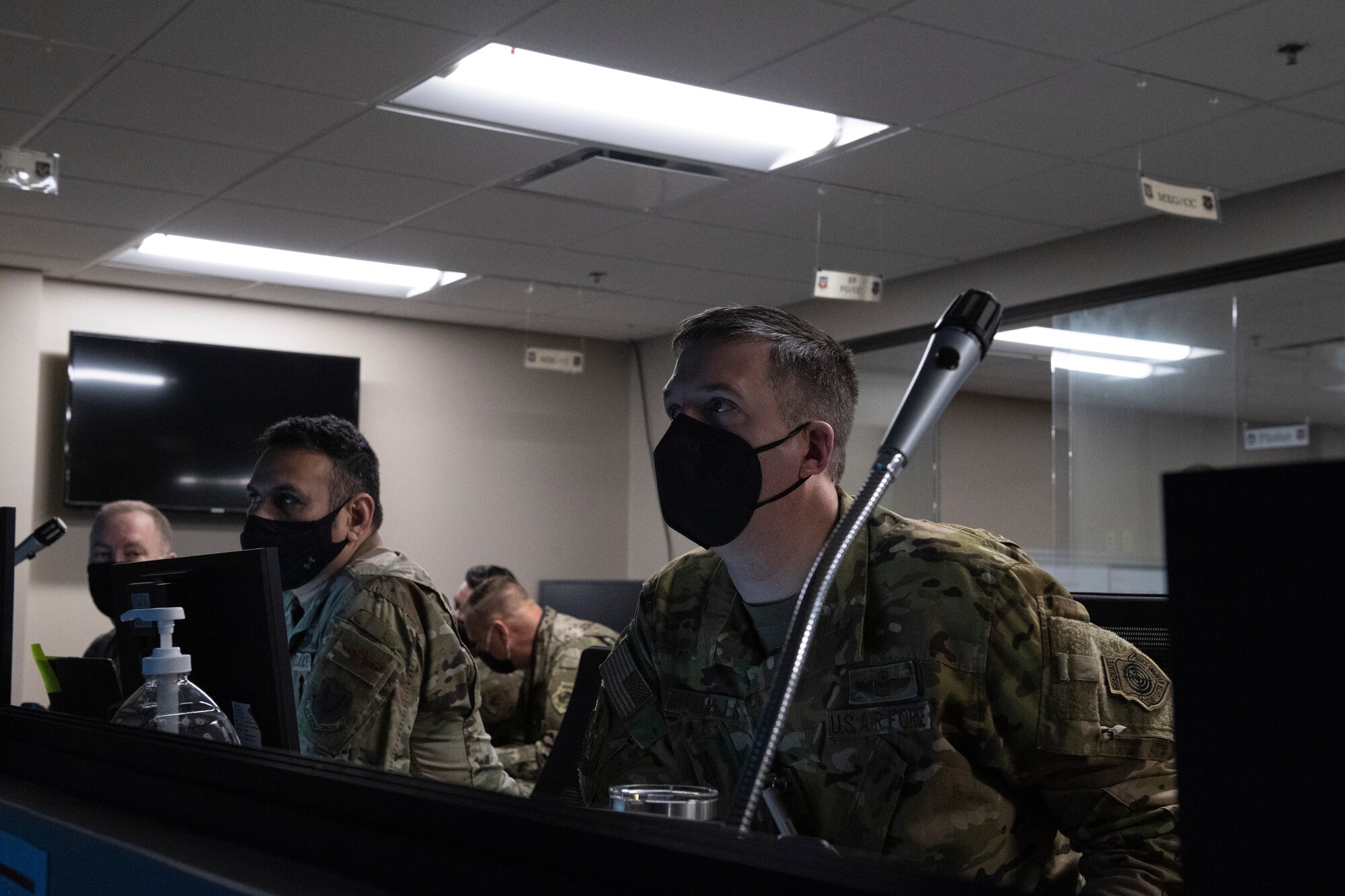 A photo of two Airmen sitting at computers.