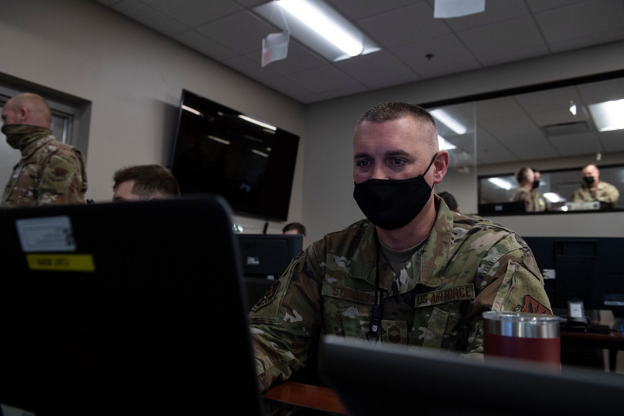 A photo of a man sitting at a computer.