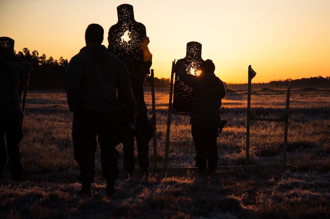 Marines with U.S. Marine Corps Forces Special Operations Command build targets before beginning the live fire portion of AK-47 weapons familiarization training aboard Marine Corps Base Camp Lejeune, N.C., March 22, 2018. The training ensured Marines’ familiarity and proficiency in maintaining and firing the AK-47 weapon system through in-depth instructional courses and live fire drills. (U.S. Marine Corps photo by Marine Sgt. Janessa K. Pon)